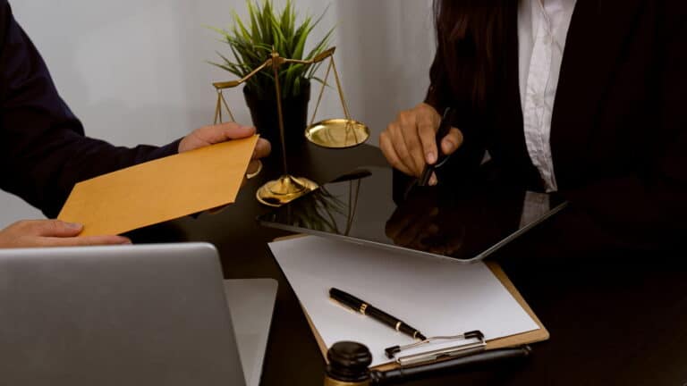 Focus Is On The Paperwork As Two Personal Injury Lawyers Discuss A Clients Case 768X432 1